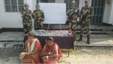 Two women sitting after being nabbed by BSF