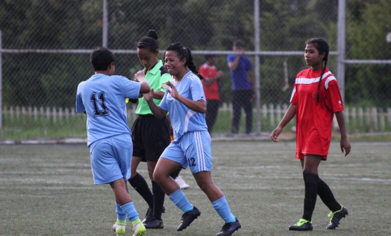 Laitkor's Nisilia Majaw (No. 12) is congratulated on scoring a goal.