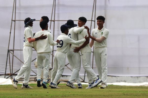 Meghalaya's Banialam Mylliemngap (second right) is congratulated on getting a wicket.