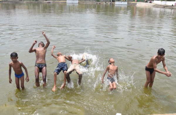 Children beat the heat with a splash in Ranchi on Monday. UNI photo