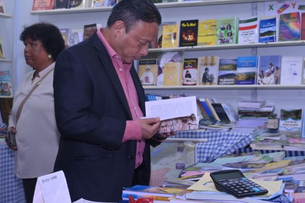 Minister Paul Lyngdoh sifts through a book at the Shillong Book Fair on Wednesday. Photo by NBT