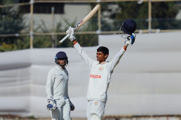 Baroda's Smit Rathva raises his bat on reaching a century. Photo sourced