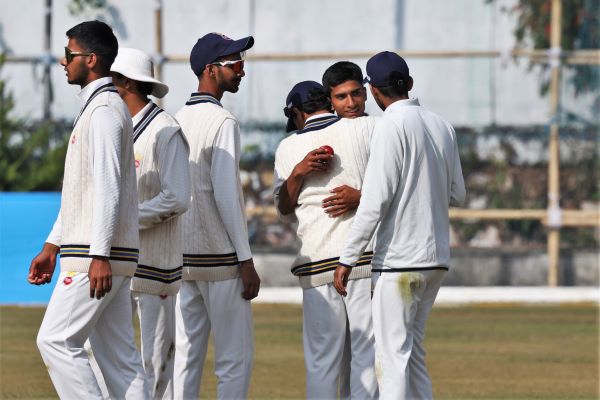 Delhi's Udhav Mohan (second right) celebrates taking the last wicket. Photo sourced