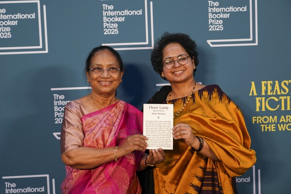 Banu Mushtaq (left) and Deepa Bhasthi hold a copy of Heart Lamp. Photo from the post of @nilanjanaroy on X