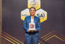 Riiohlang Dhar with the award. She is in a blue suit and smiling at the camera. Photo sourced