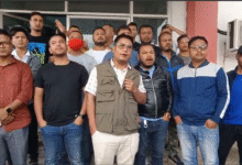 Six JNC members standing the front row, on Thursday. The person in the middle, who is wearing a white T-shirt and a grey jacket, is speaking.