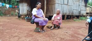 Speciality Marngnar (left), sitting on a murrah, with her sister Ferocity in front of their house at Sohliya in Ri Bhoi. Photo by MM