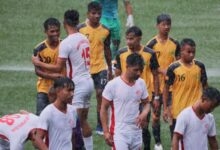 Malki (white) and Nongrim Hills (yellow-black) players coming off the pitch after the match was abandoned. Photo sourced