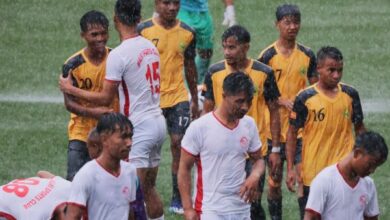 Malki (white) and Nongrim Hills (yellow-black) players coming off the pitch after the match was abandoned. Photo sourced