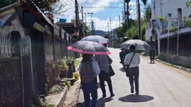 Blazing sun: Students guard themselves from the heat. Photo by MM