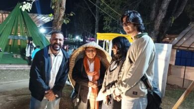 Banu Mushtaq (centre) tries a knup, or Khasi umbrella, at the Shillong LitFest at Ward's Lake in the city recently. Photo by MM